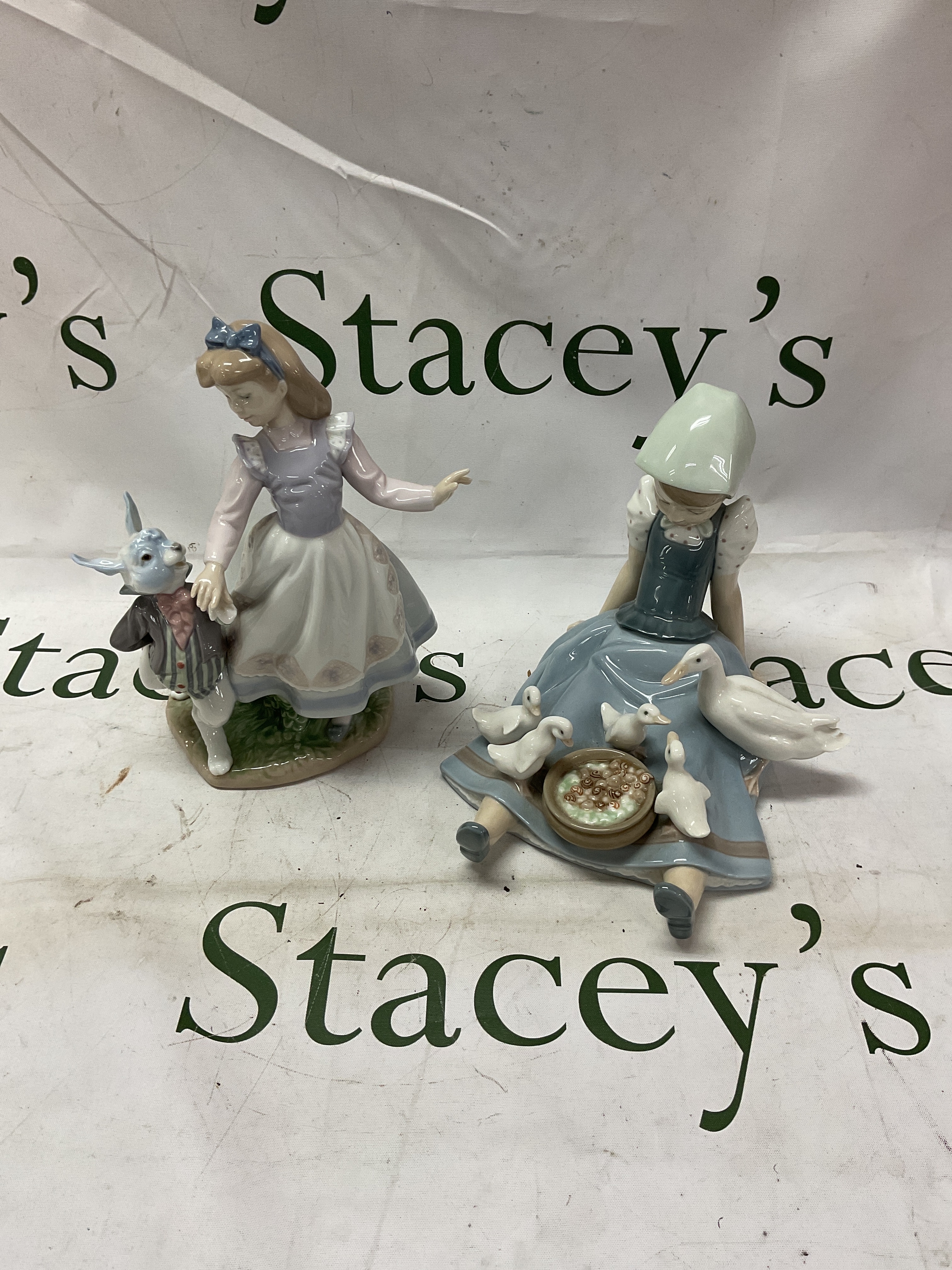 Lladro Alice and the white rabbit, by designer J L Alvare model number 5740, along with Lladro figure of a seated girl feeding ducklings.