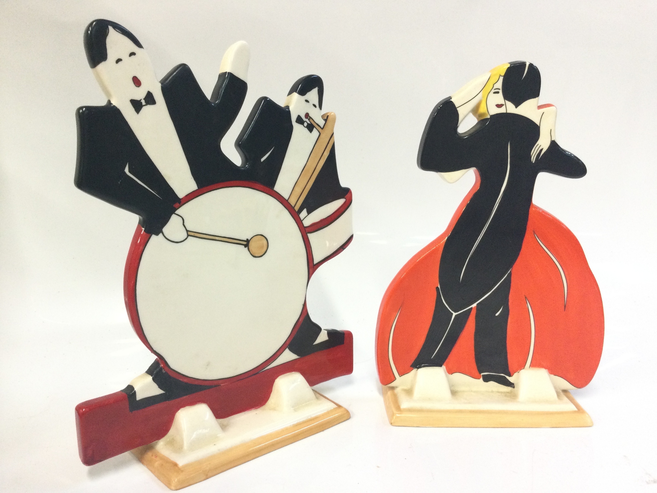 Wedgwood reproduction Age of Jazz Clarice Cliff Bizarre porcelain figures, Man With A Drum and a Dancing Couple. Dancers signed Pauline a Tomlinson and Elizabeth Shaw. Damage and restoration on the drummer figure, 19 and 20cm tall