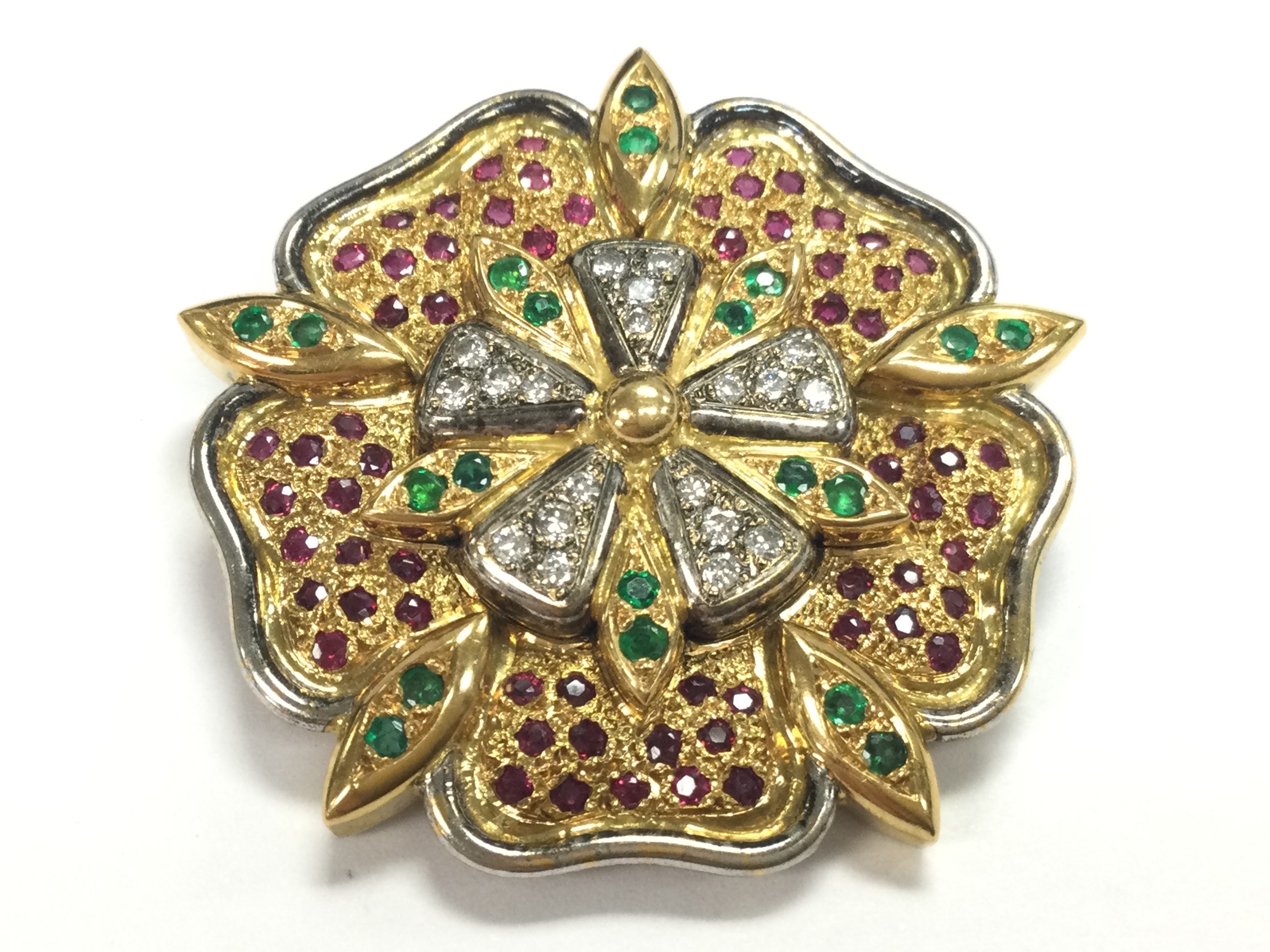 An 18ct gold brooch set with multi stones possibly by Grant McDonald, 4cm wide, 28.5g