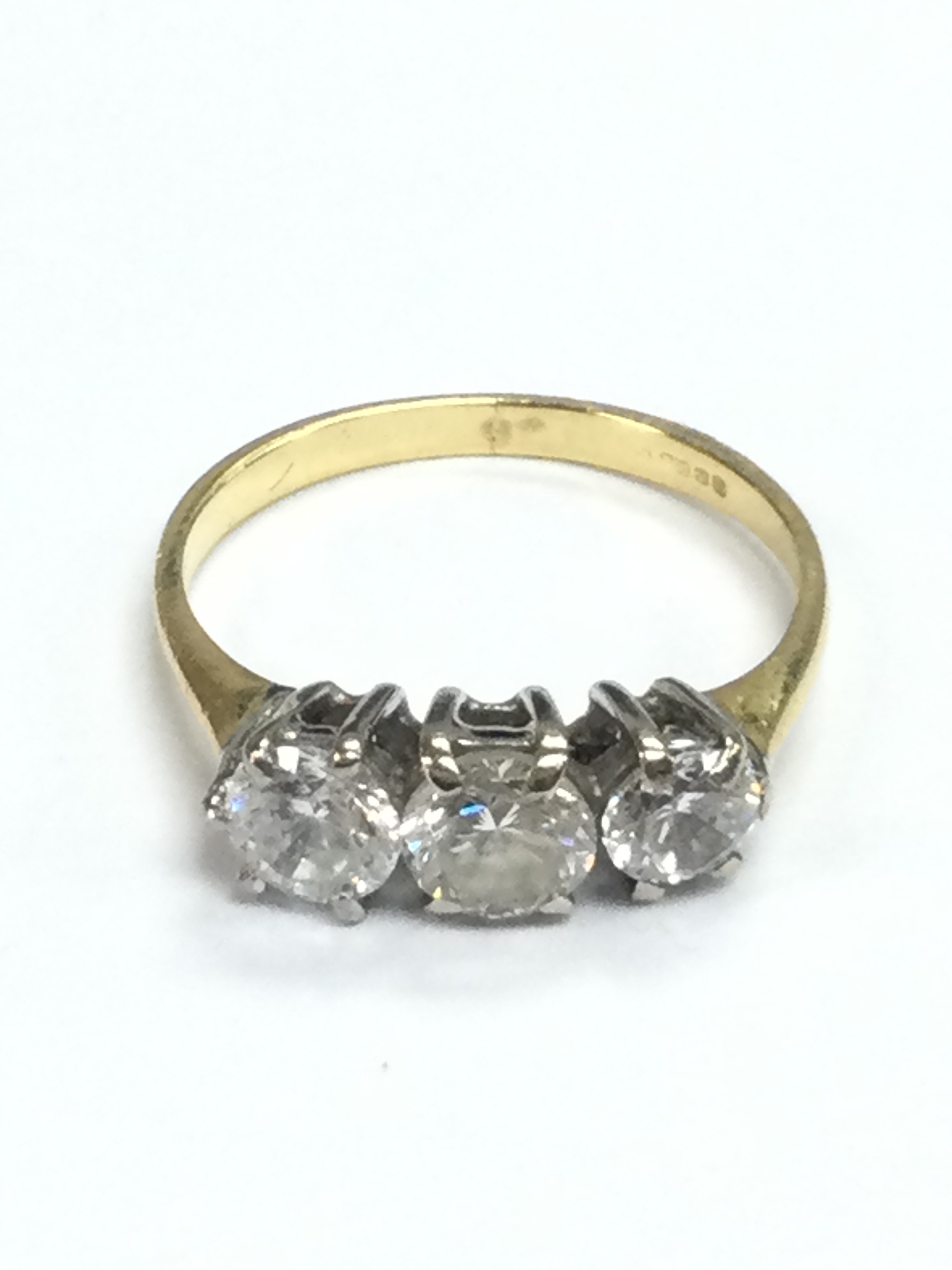 A 18ct gold three white stone ring, size J, 2.2g total weight