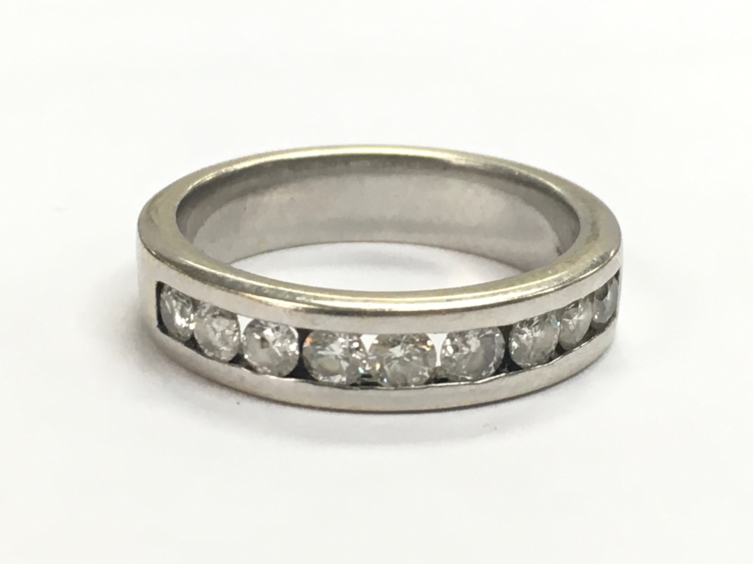 A diamond stone set 14ct white gold half eternity ring. 4.3g, size K/L