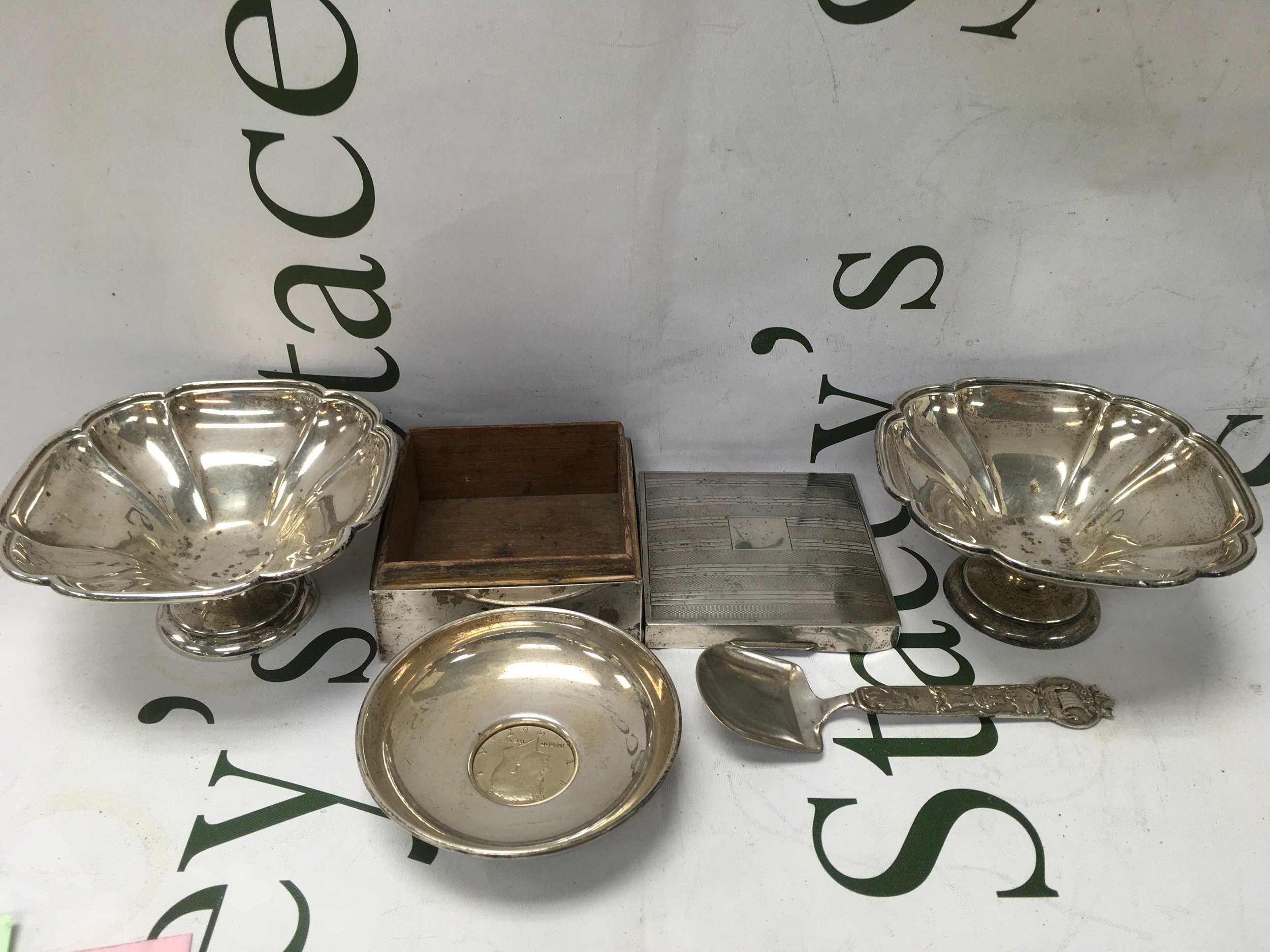 Two silver dishes, an American Silver dish with a coin inset and a silver cigarette box and spoon. 