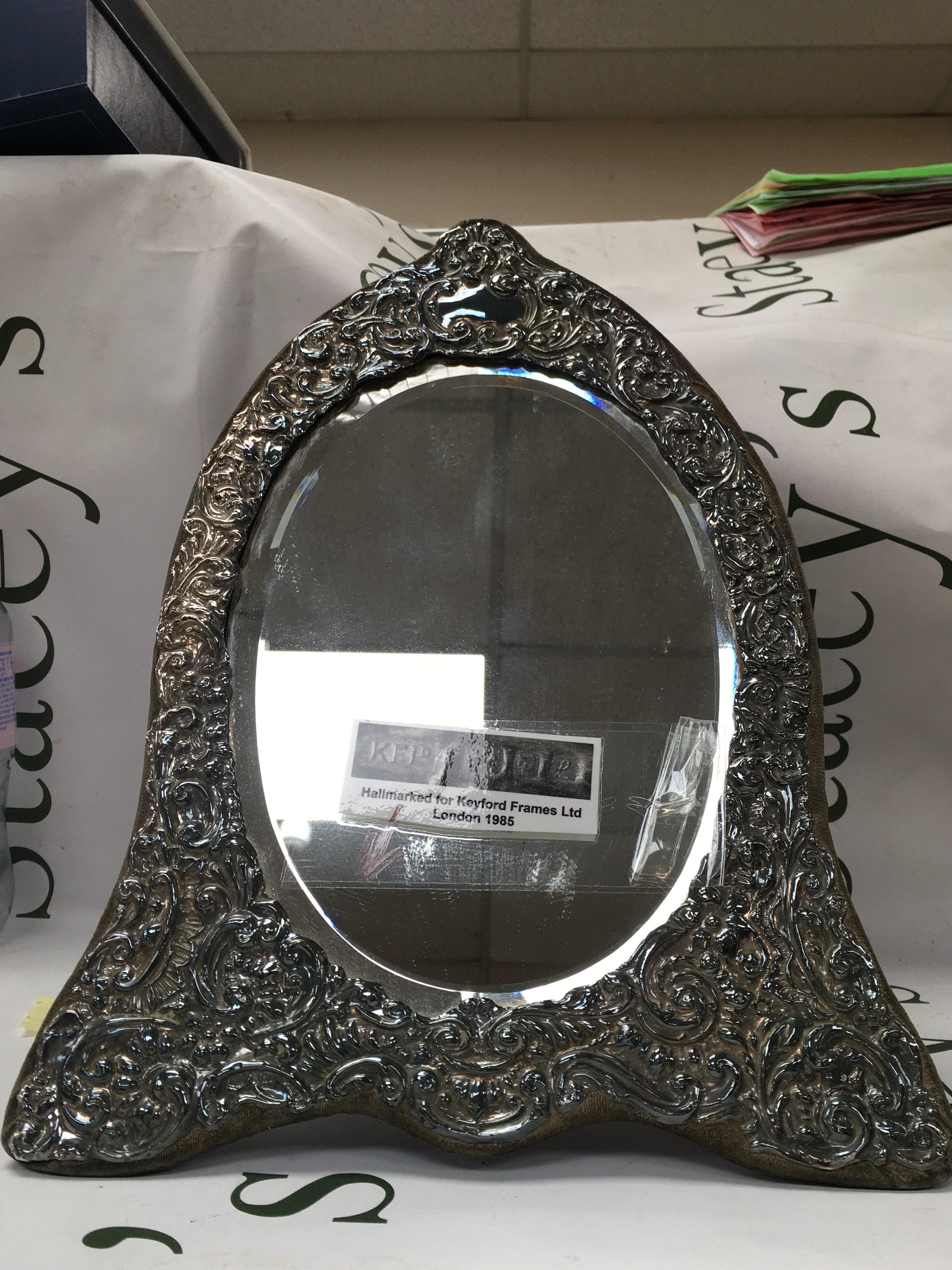Hallmarked hearth shaped Silver mirror, 32cm high made by Keyford Frames, London 1985. 