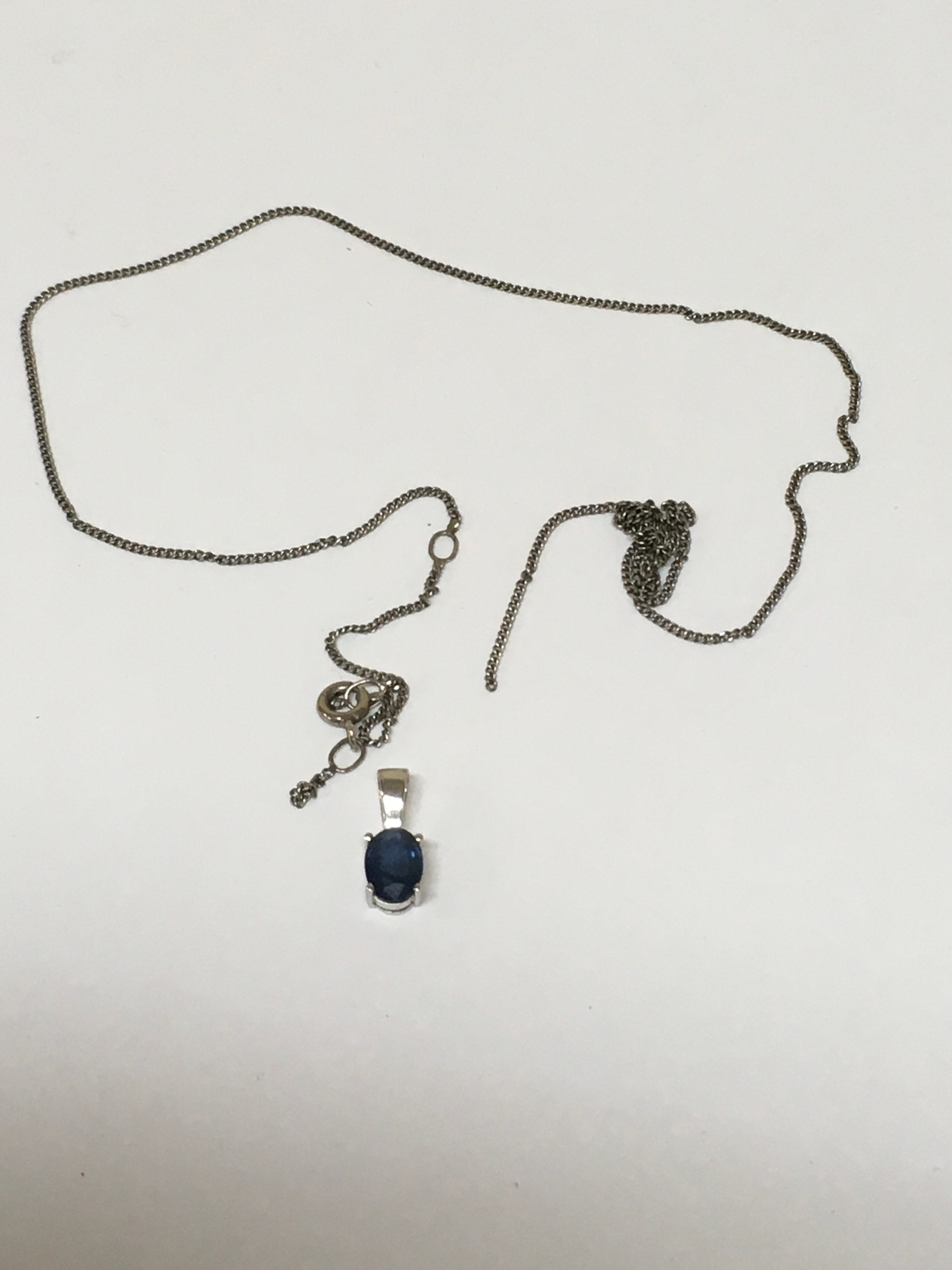 Silver Chain (A/P) Carat White Gold pendant with inset Sapphire. Includes The Diamond Store London box.