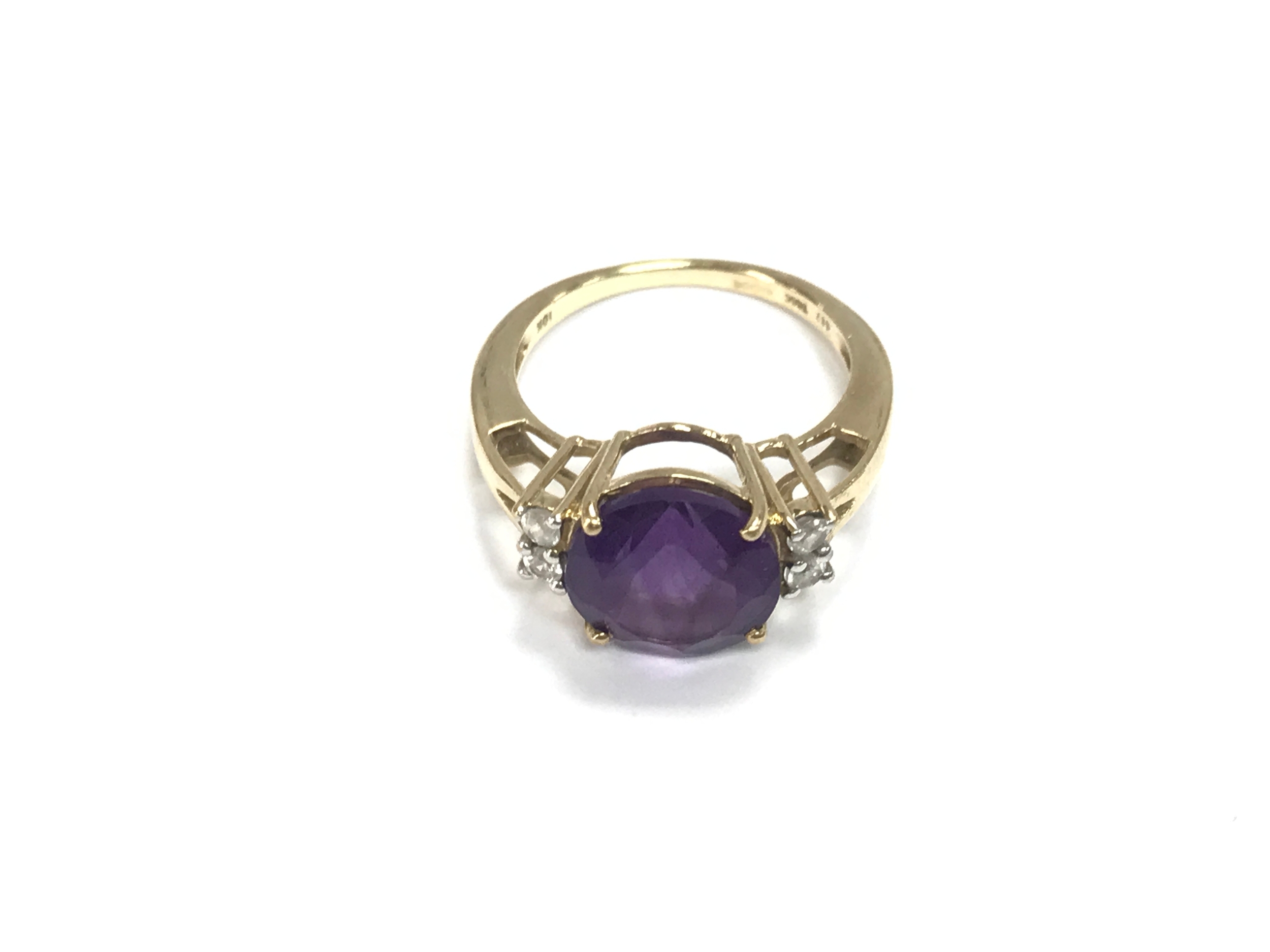 A 9ct gold ring set with a purple stone. Size L 1/2 and 3.2g
