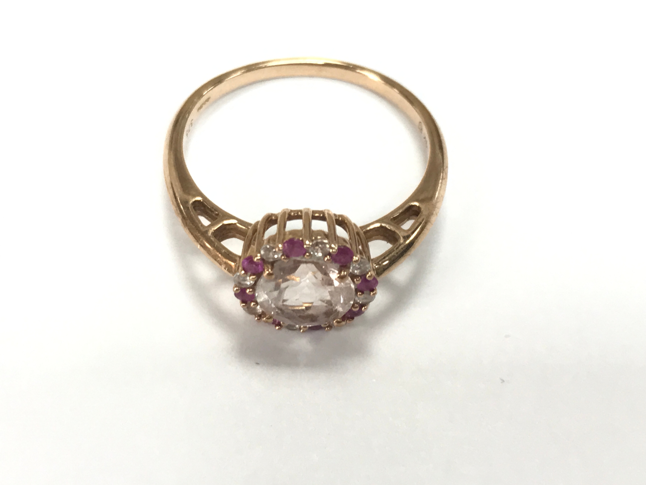 A 9ct rose gold r8ng set with morganite pink sapphire and white zircon. Size R 1/2 comes with large ring box.