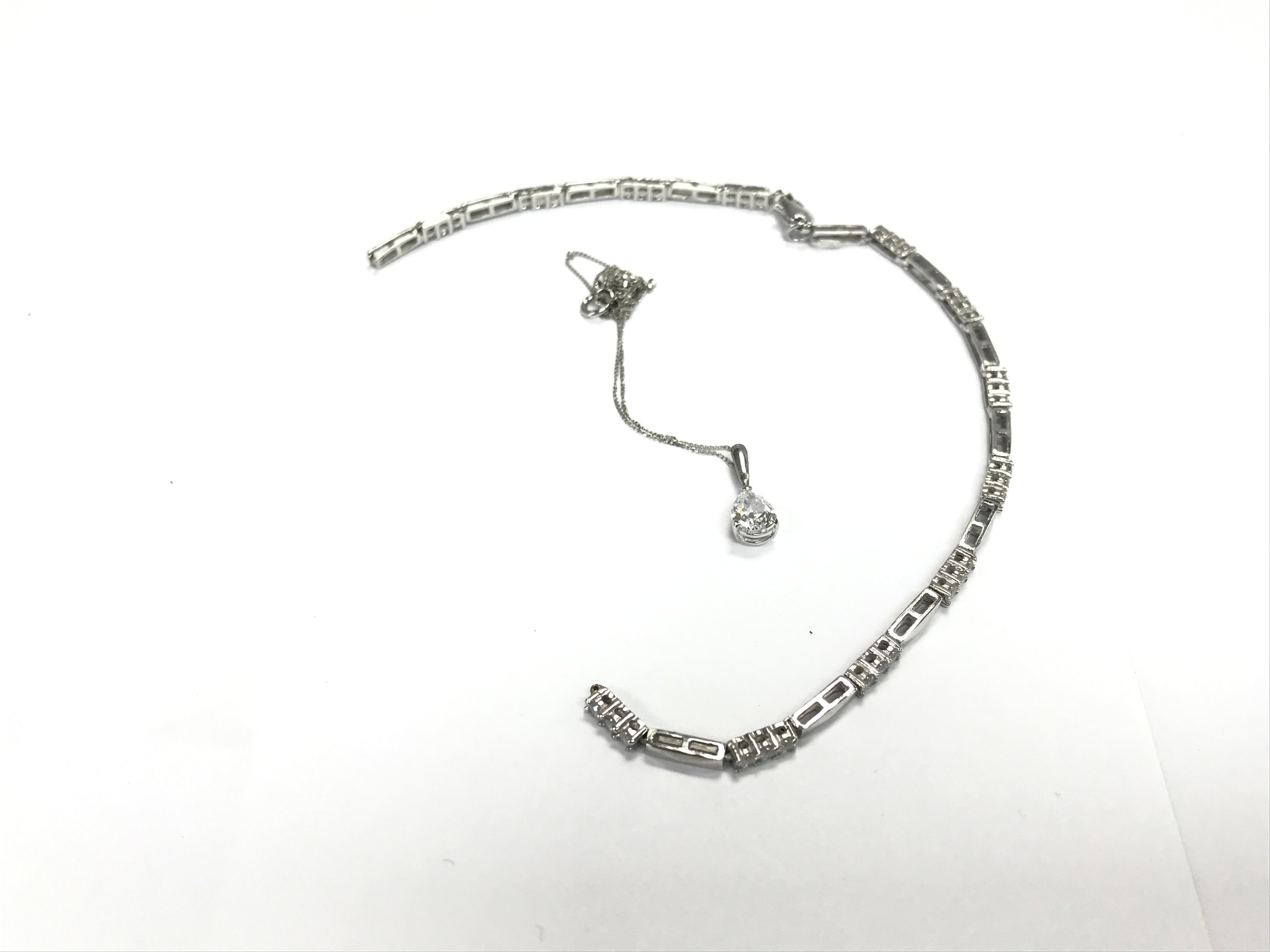 Two 9ct white gold items including a broken bracelet set with white stones. 6.3g total.