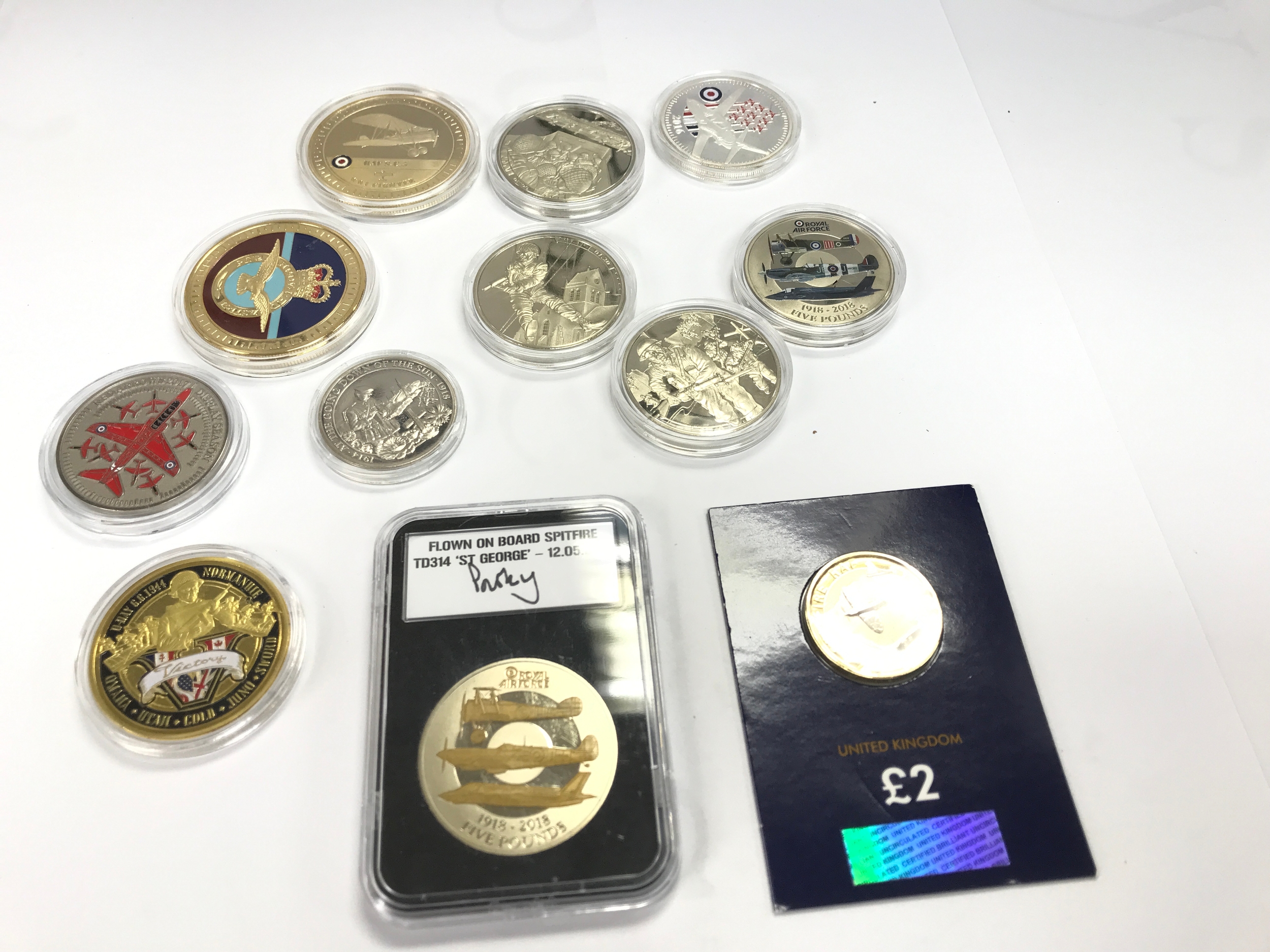 A collection of various military themed commemorative coinage.