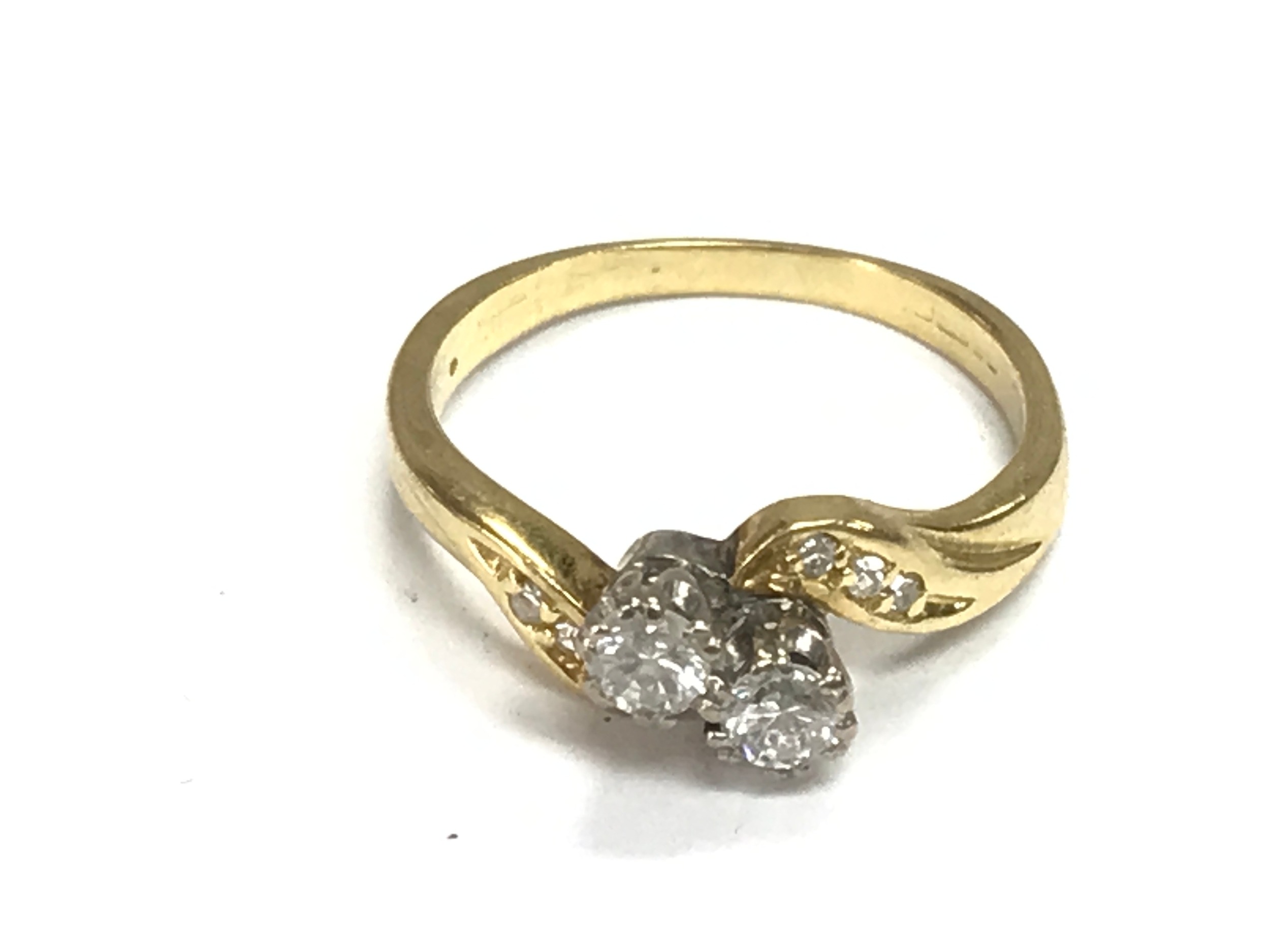 A gold diamond cross over ring. Hallmarks worn away. Size K and 2.8g