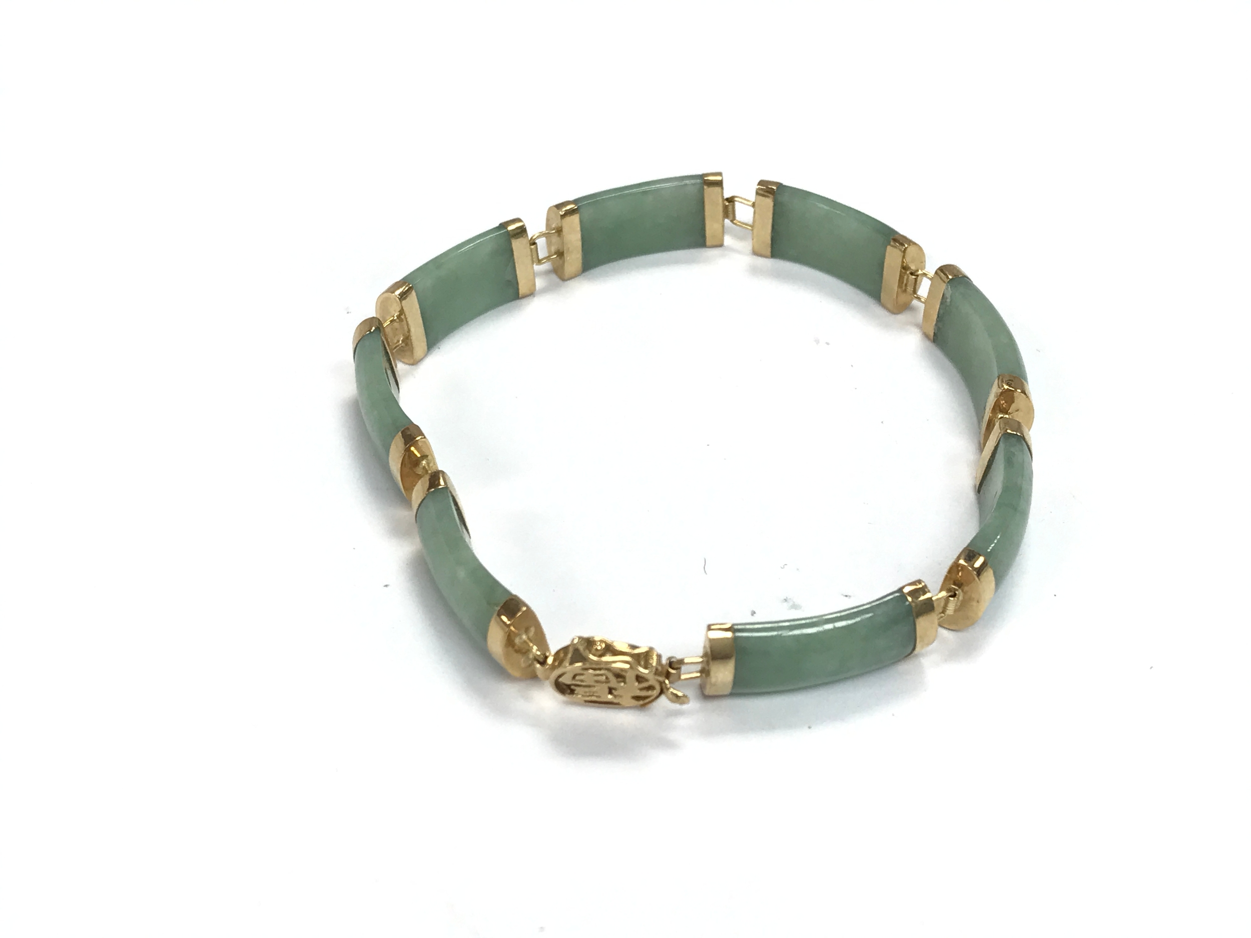 A 14ct gold and jade bangle / bracelet in need of repair.