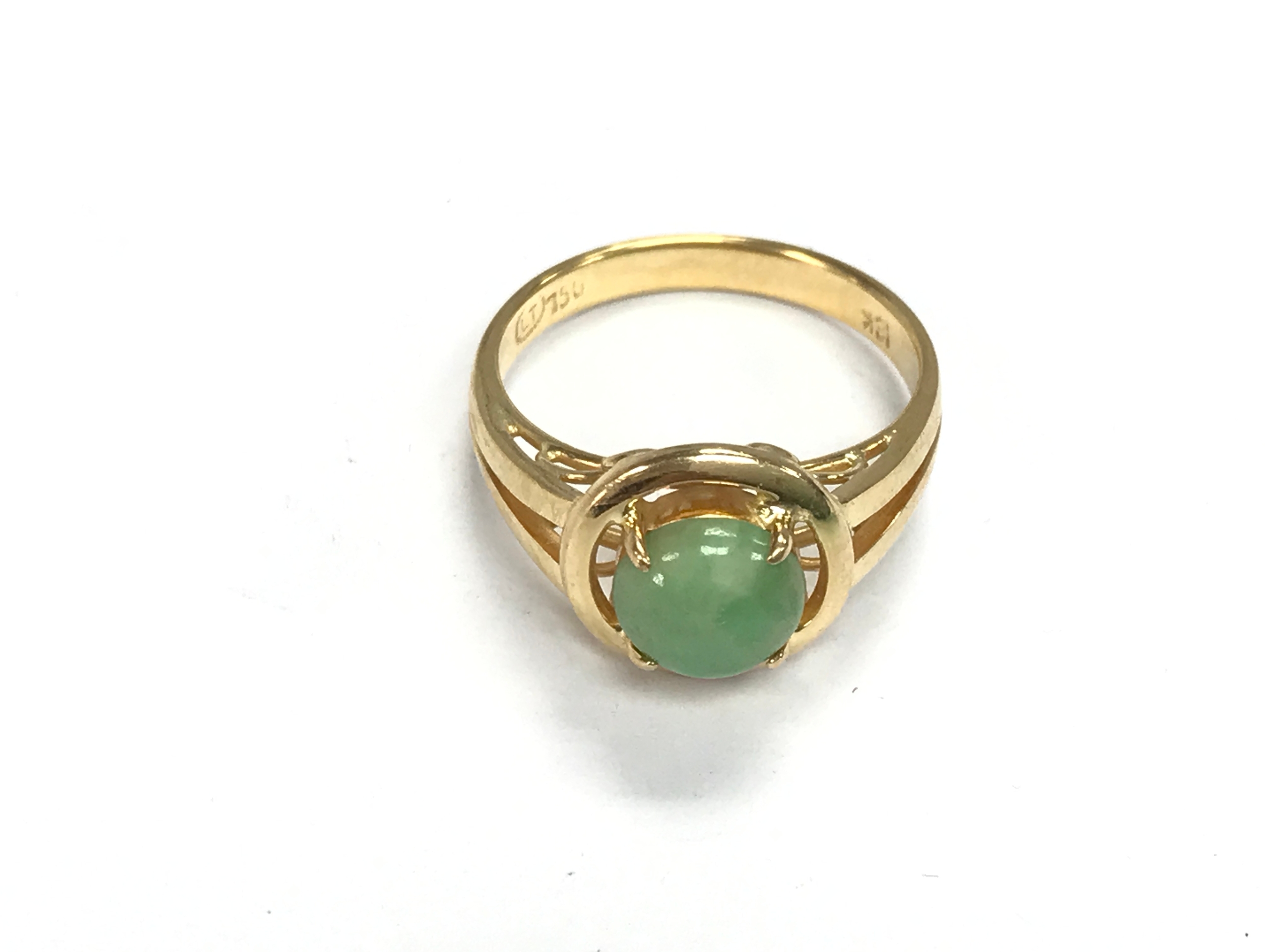 An 18ct gold ring set with green stone Cabochon. size P 1/2 and 5g