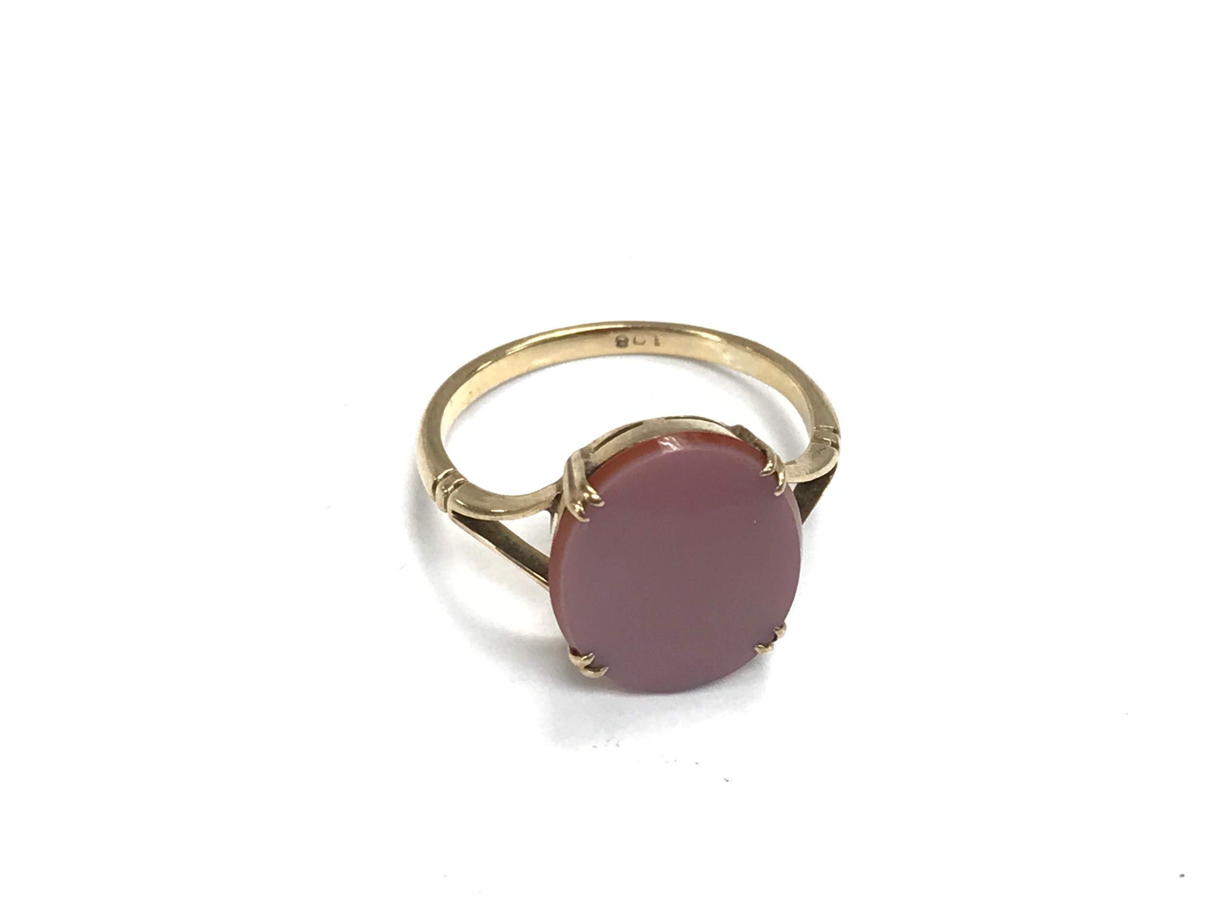 A 9ct gold ring set with a coloured oval. Size Q 1/2 and 2.7g