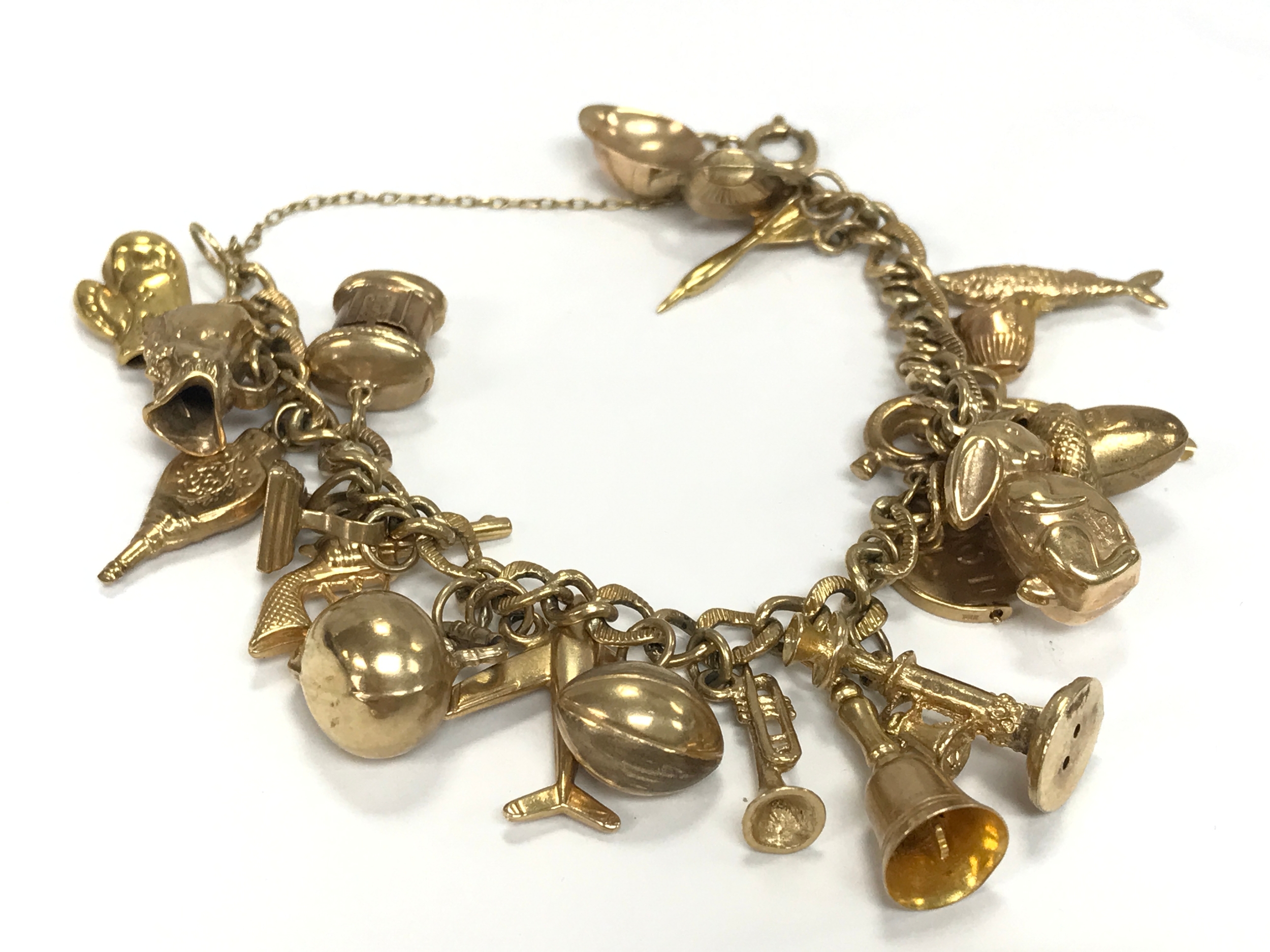 A 9ct gold charm bracelet, 10cm wide. 33.6g 