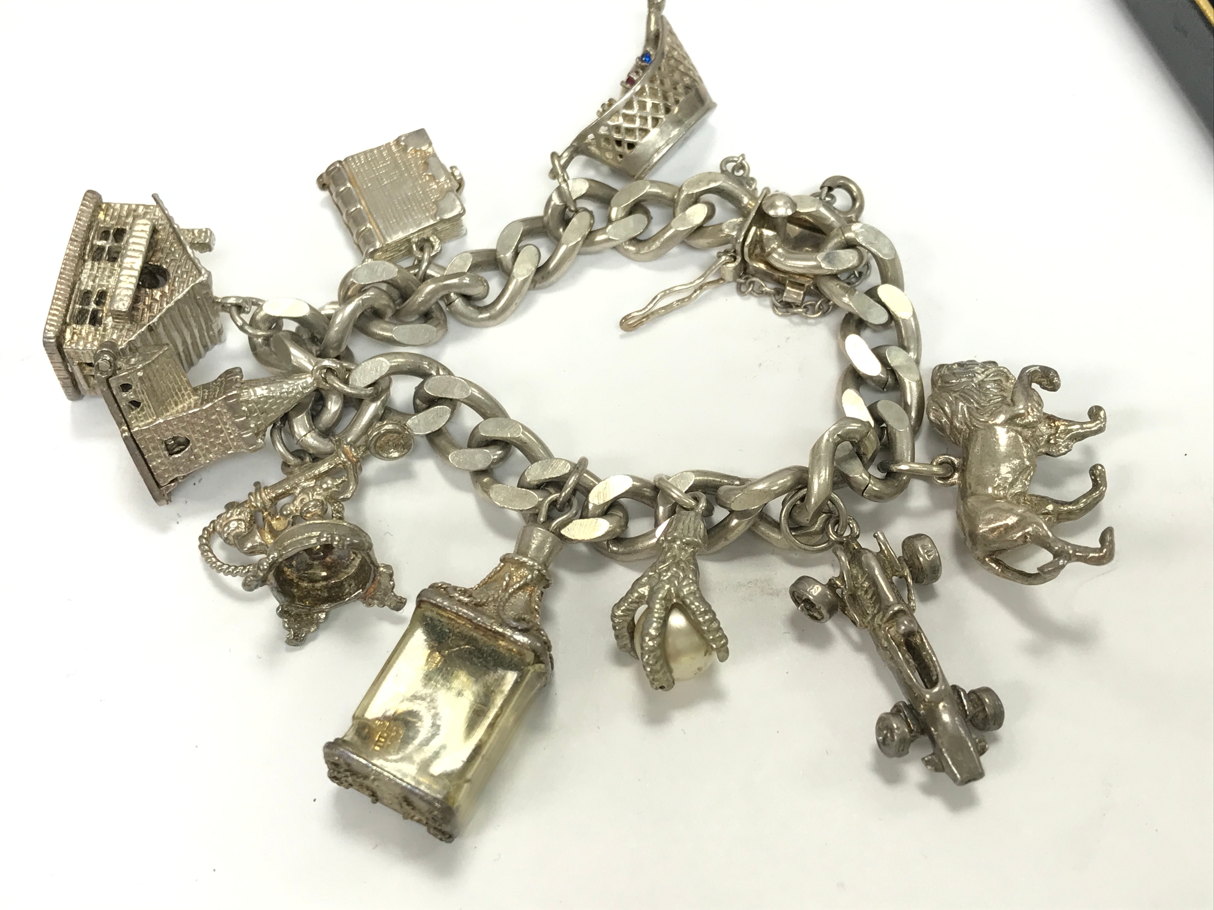A silver charm bracelet , 74.9g total weight 