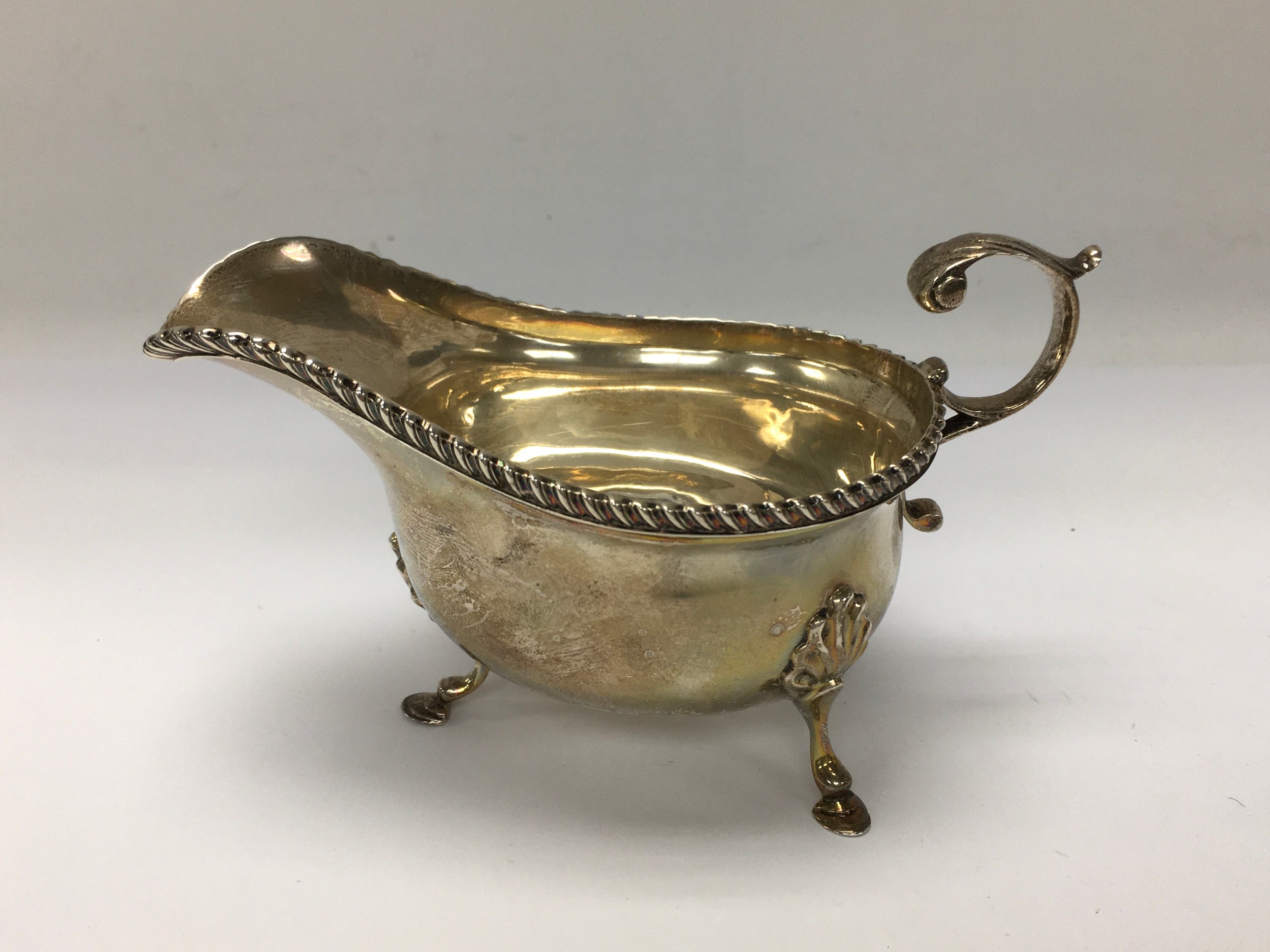 A silver sauceboat having gadrooned rim. Chester hallmarks for George Nathan and Ridley Hayes