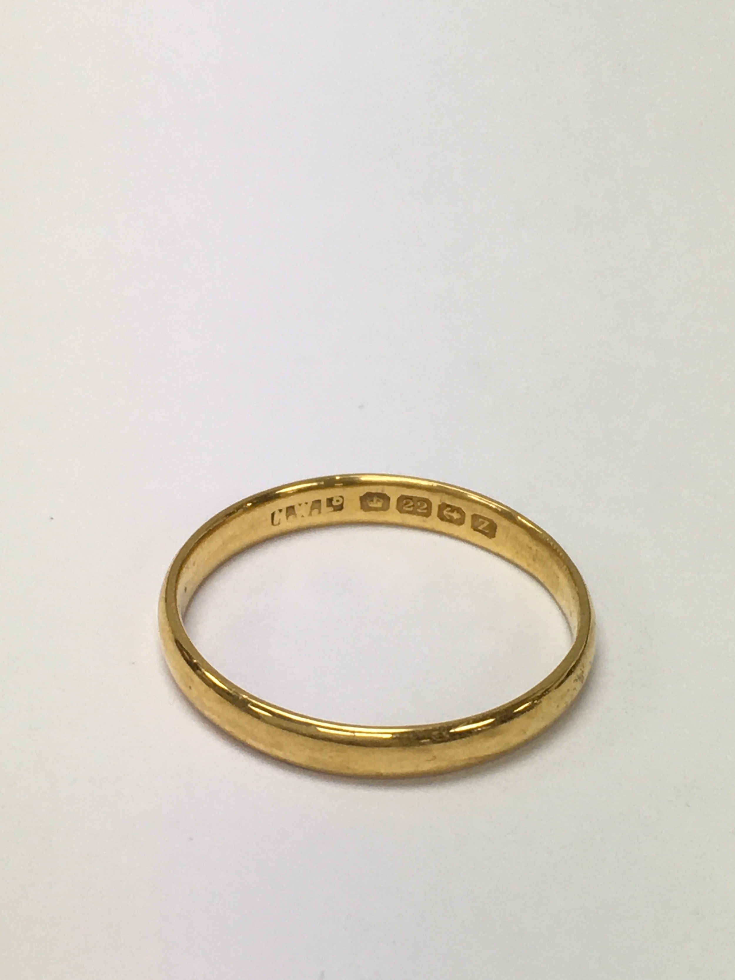 A 22ct gold wedding band. Approx size U, large size.