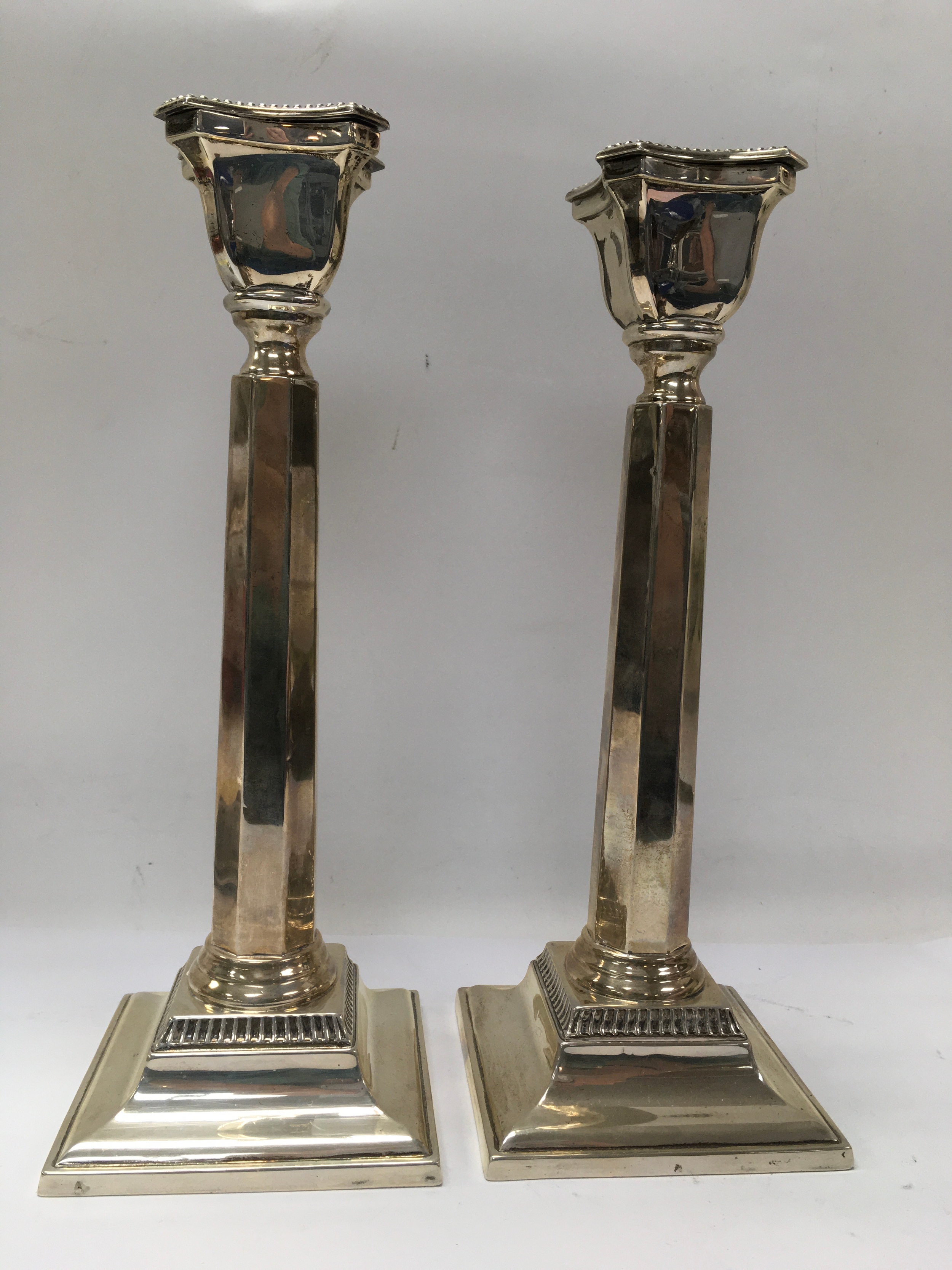 A pair of large silver fluted candlesticks. London hallmarks for Michael Starkey.Approx 28" high, hollow bases.