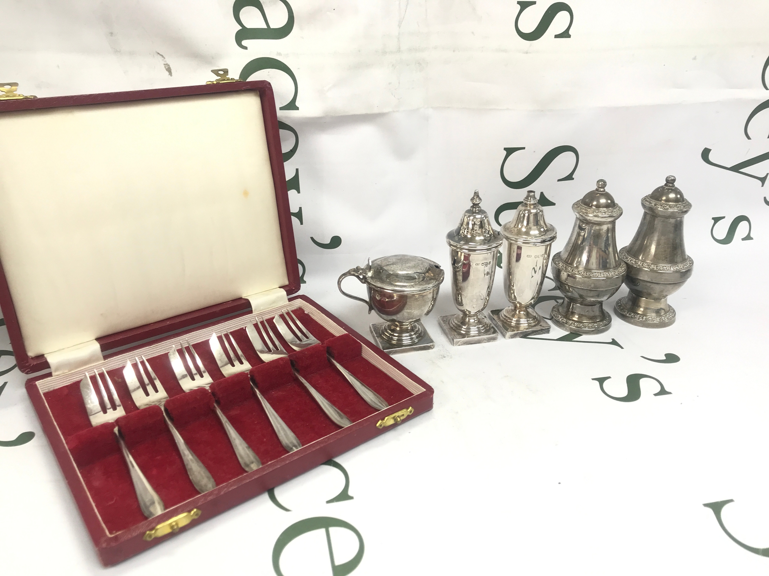 Silver hallmarked salt and pepper shakers, a set of silver hallmarked tea forks , non silver shakers . 280g