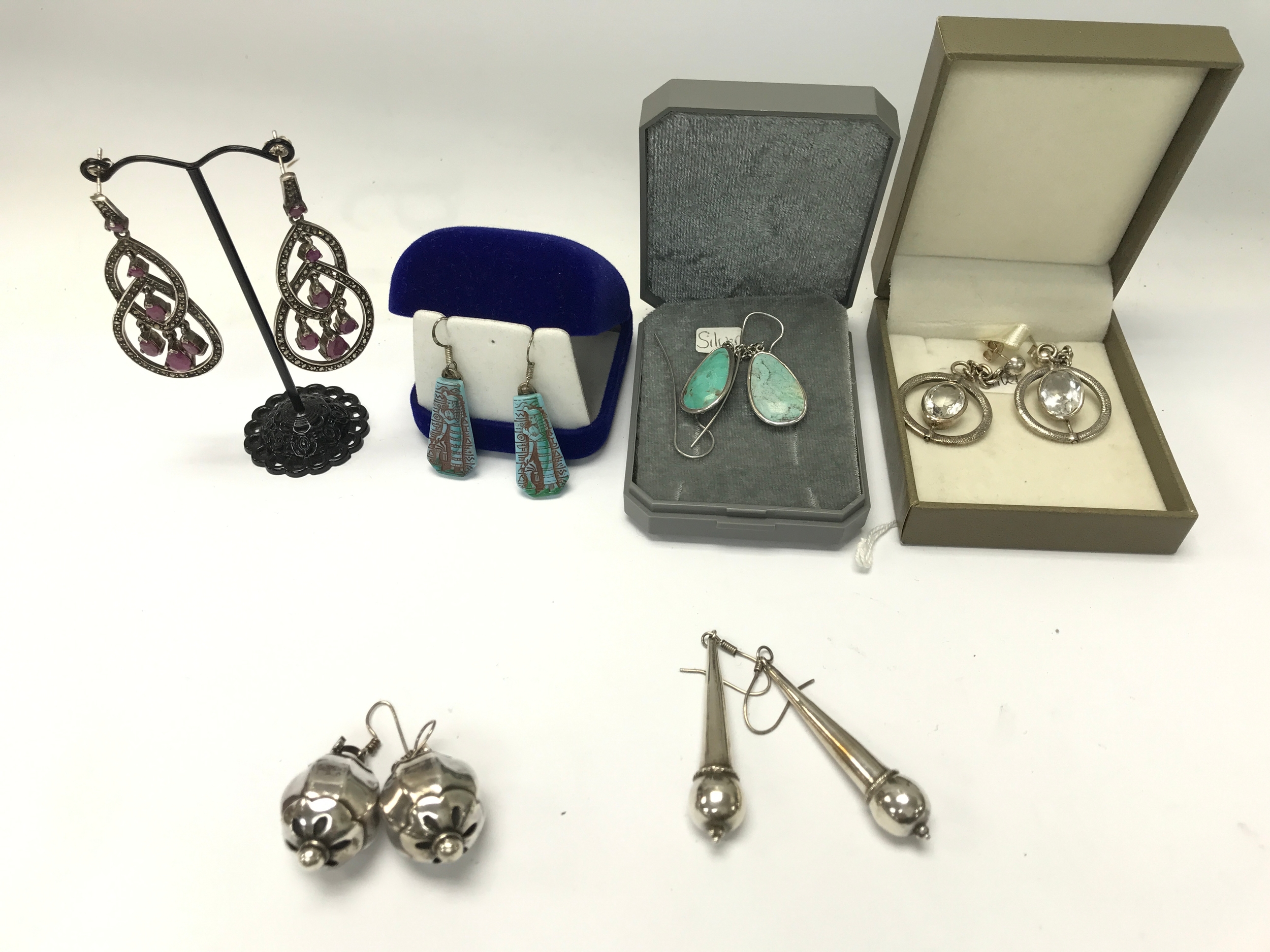 Small collection of assorted silver earrings.