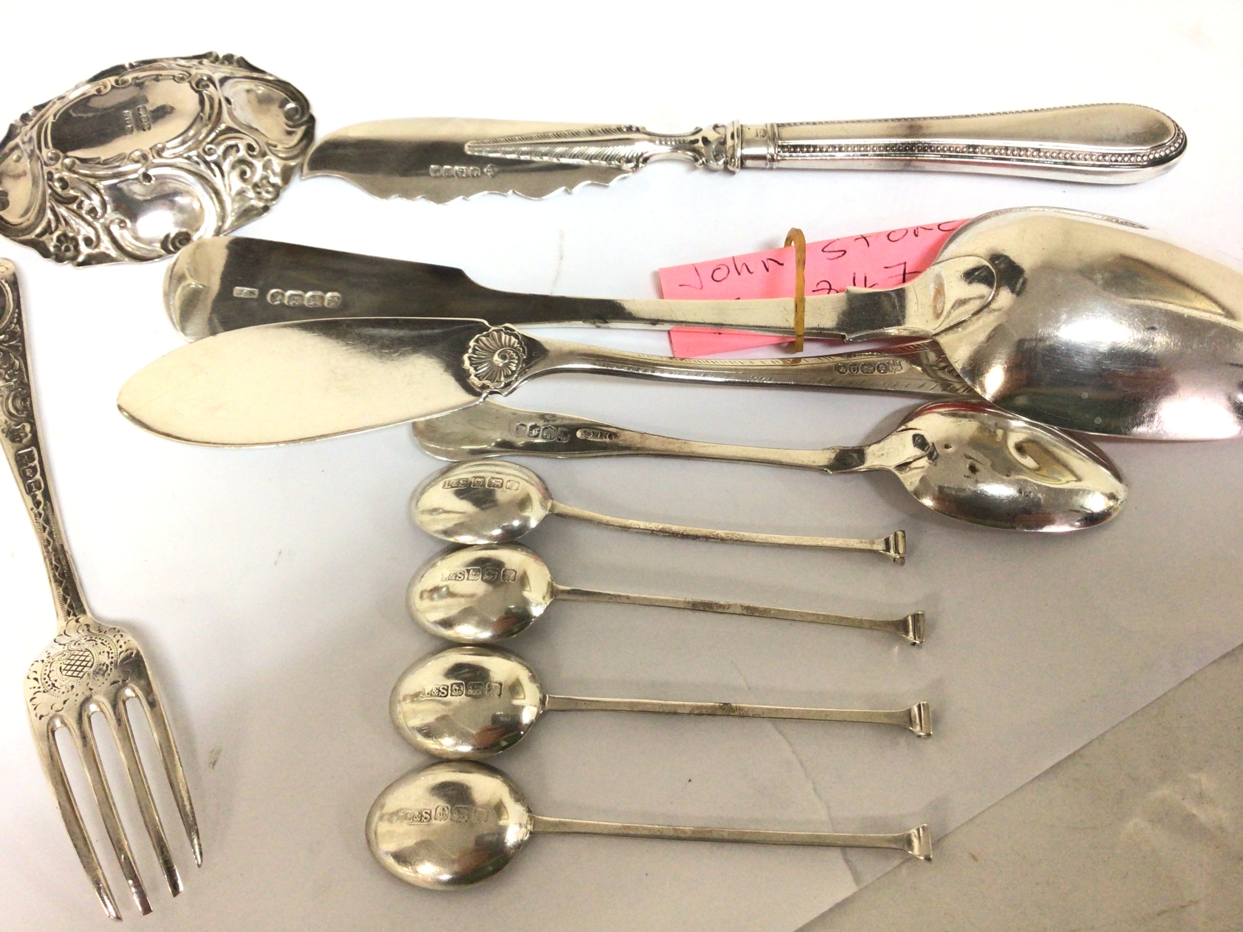  A collection of silver cutlery spoons coffee spoons a small dish total weight. 250g approximately.