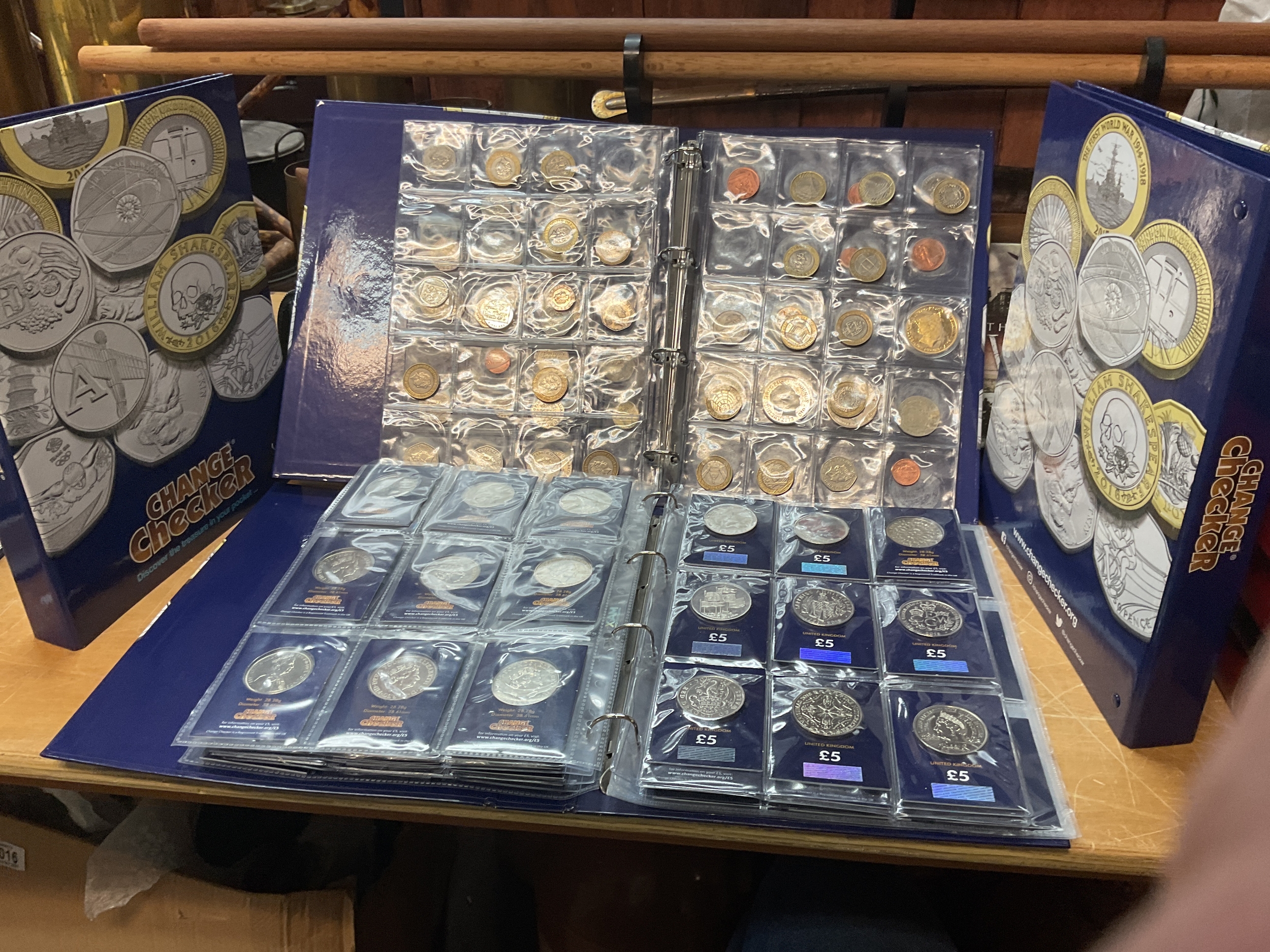 Four albums of change checker coins, two full sets of A-Z 10 pence then lots of 50 p, £2 & £5 examples.