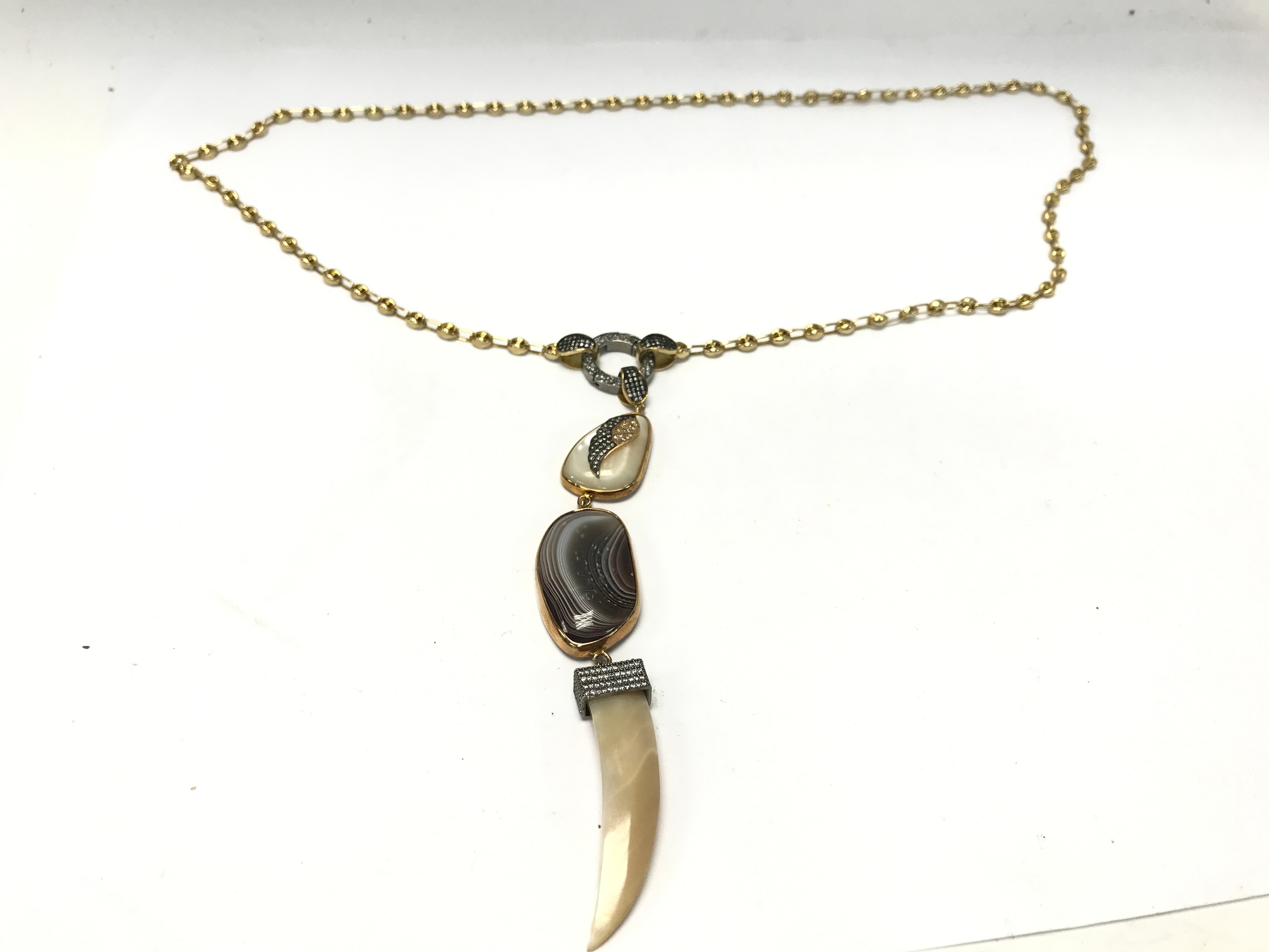 MER'S Gold plate & Silver Cubic Zirconia Agate Necklace, featuring a distinct layered drop design centered around a polished banded agate stone