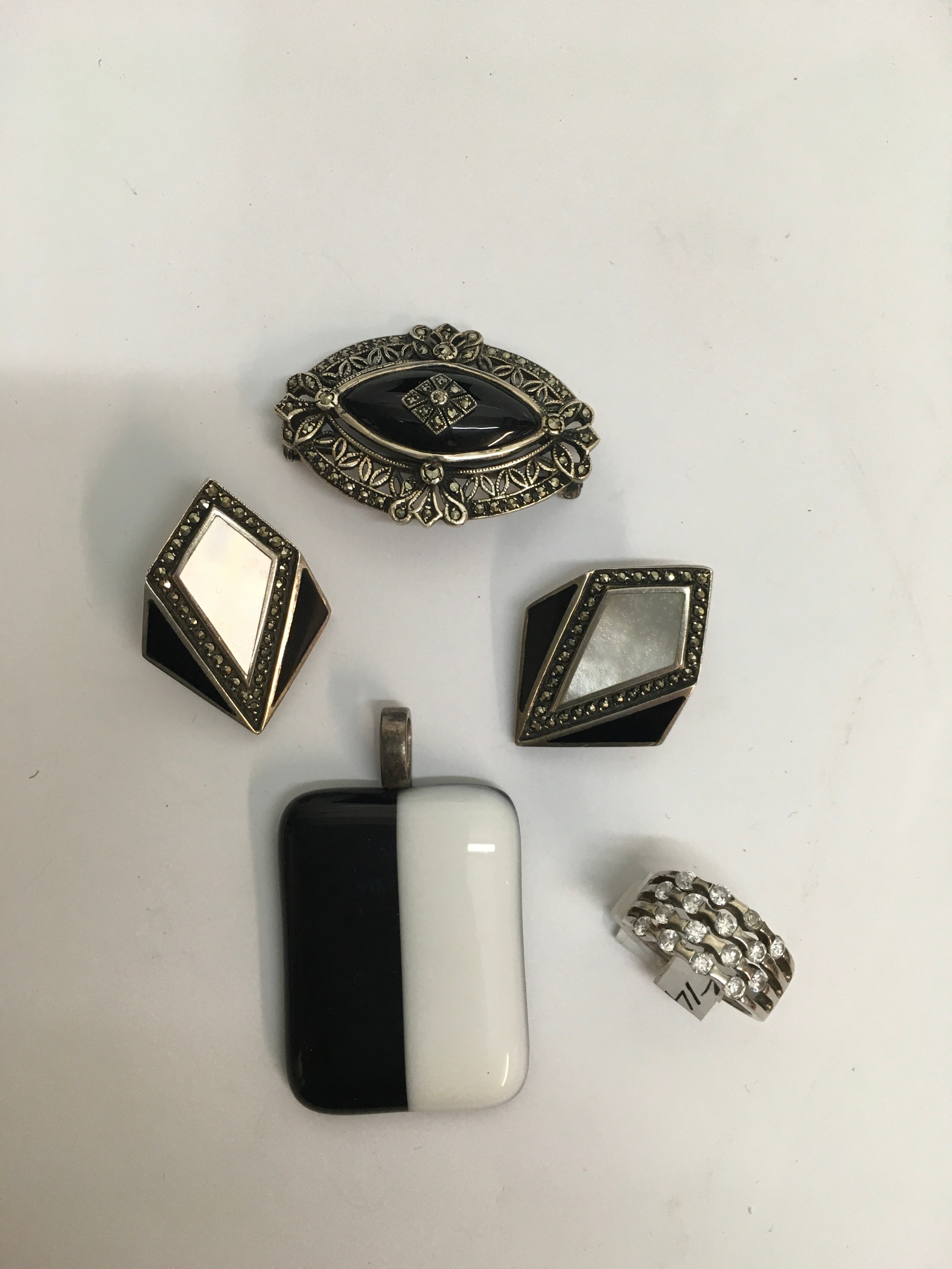 A 925 continental silver and marcasite brooch, a pair of silver Art Deco style clip earrings, London hallmarks for plus a silver ring and pendant