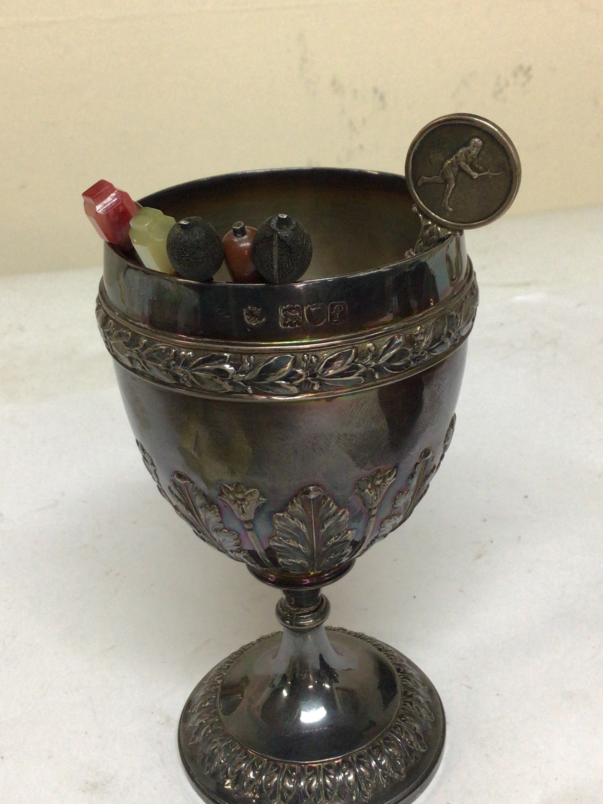  A silver wine cup London hallmarks silver coffee spoons and a silver Tennis trophy spoon. Total weight 290g 