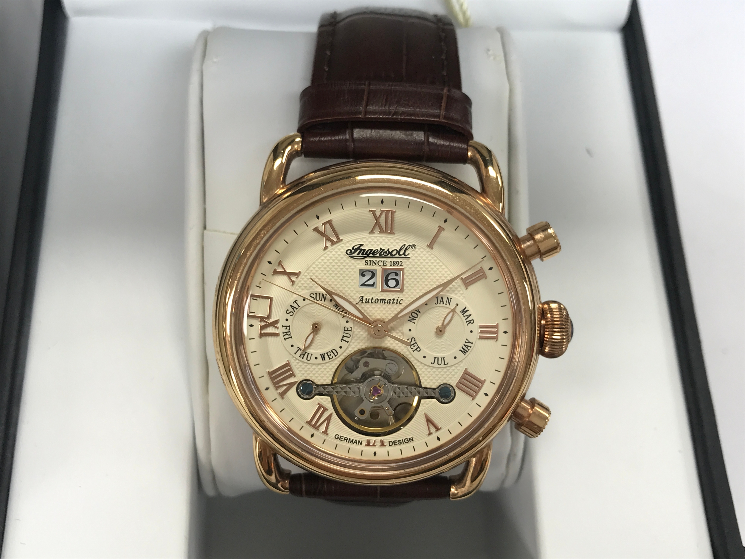 Ingersoll The New England Automatic watch, which features a cream dial with rose gold-tone Roman numerals and a distinctive skeleton opening at the 6 o'clock position