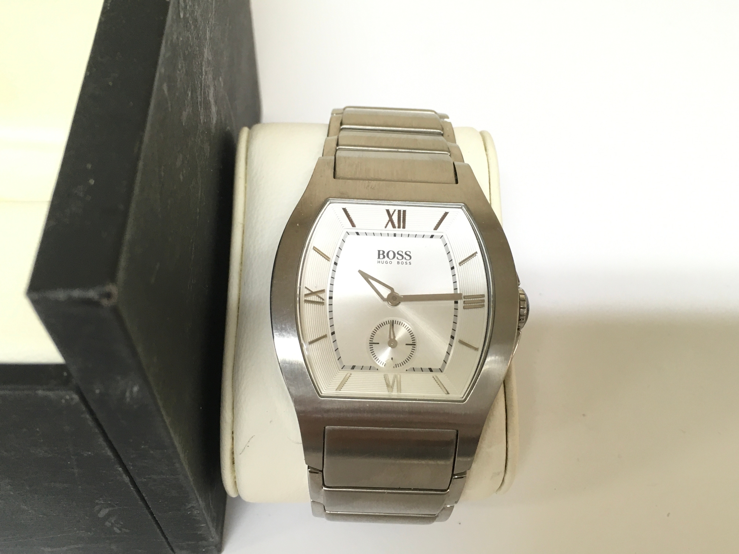 stainless steel Hugo Boss quartz wristwatch featuring a distinctive tonneau-shaped case and a clean white dial with a small seconds sub-dial. Boxed. seen running.