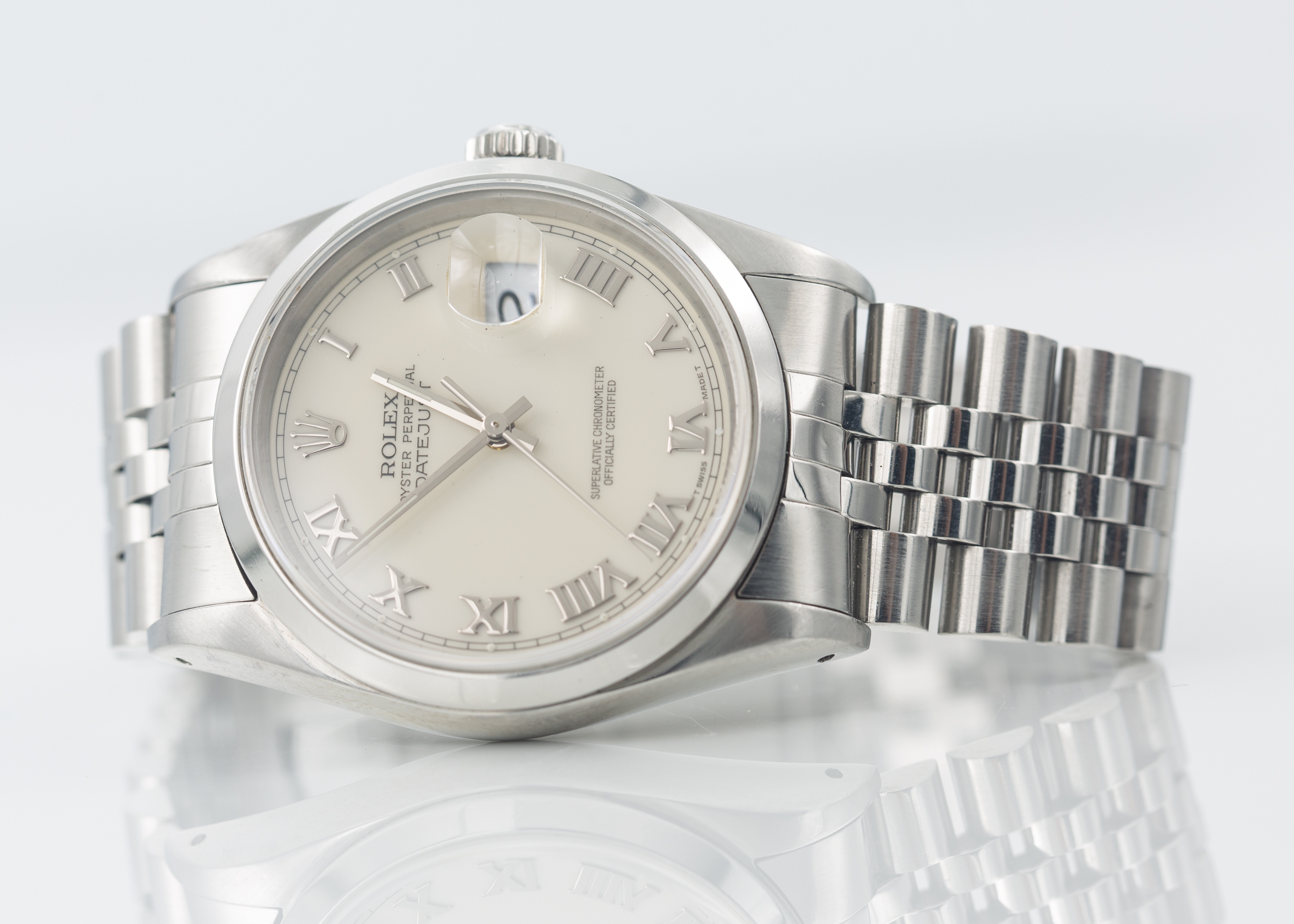 Rolex Datejust 16200 smooth steel bezel and striking white Roman numeral Buckley dial. Winds and runs and comes with box and swing tag.