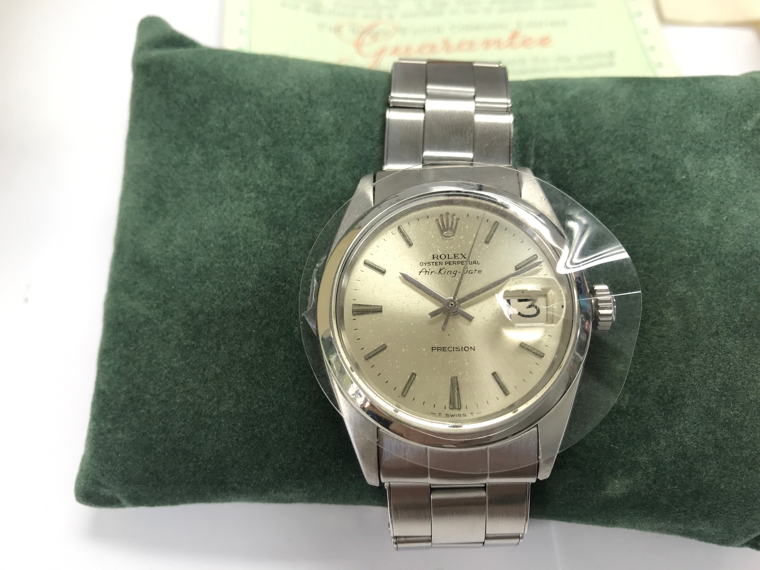 Rolex Oyster Perpetual Air-King-Date Ref. 5700. Silver dial with baton markers and a date window featuring a Cyclops lens. Circa 1966. Winds and runs, comes with box and paperwork (pictured) and service paperwork. Last serviced July 2021.