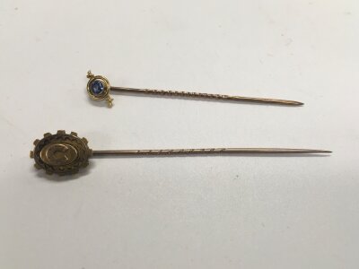 One 15ct gold stick pin and one other yellow metal stick pin. Approx weight 2.76 grams.