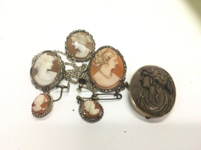 A 19th century grand tour lava rock cameo brooch with a small assortment of other cameos.
