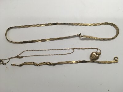 A 9ct gold bracelet and necklace set, and a gold front and back locket. Approx weight 11.7 grams.