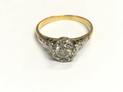 An unmarked gold and platinum solitaire ring. Size L 1/2 and 2.36g