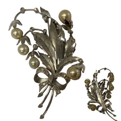 A vintage platinum (950) unmarked, 1960s floral spray bouquet design brooch inset with diamonds and pearls. 7.2cm, 31.2g.