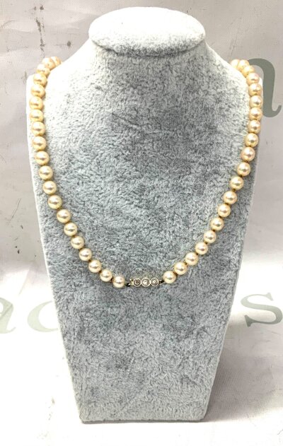 A single strand of 5-12mm graduated pearls with a gold and diamond set clasp. 46cm