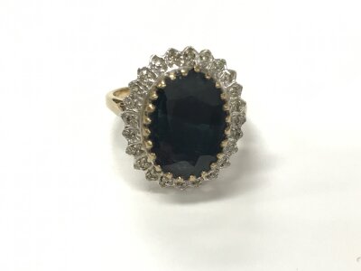 A 9ct gold ring set with large oval cut smoked quartz. Size O and 4.21g