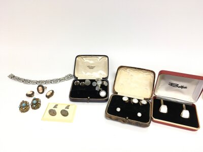 A collection of press studs and costume