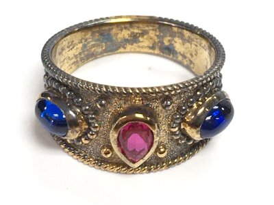 a sterling silver ring set central rubylike, size O