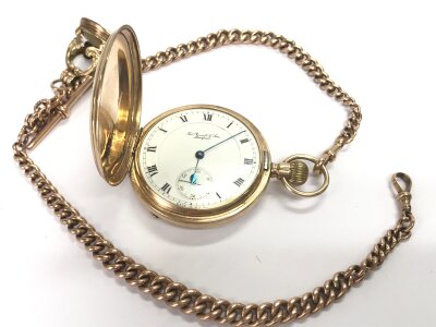 A 9ct gold hunter pocket watch with a 17 jewelled lever Waltham, Mass, USA. movement made for Thos Russell no.22017057 case no.7861 , Chester 1913. Complete with a 9ct gold double Albert with a Pearl "Dove of peace" seal. Birmingham 1940. 149.7g total weight. Chain 40cm long