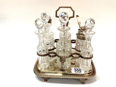 A George III hallmarked silver cruet stand, London 1811, together with a later 8 bottle cruet set some with silver tops.