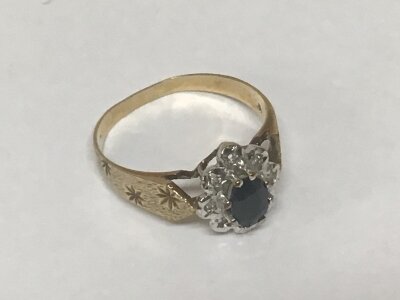 A 9 carat gold ladies ring set with a blue sapphire and chip stones weight 2grams