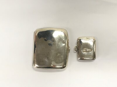 A silver cigarette case and a silver Vesta case, Birmingham hallmarks.