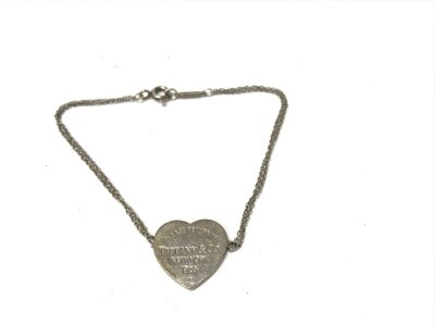 A Tiffany and Co silver heart bracelet.