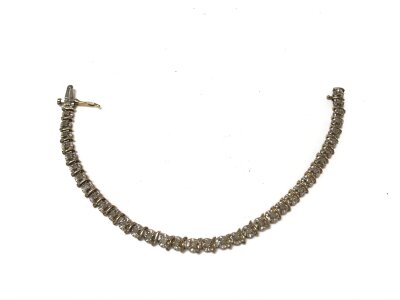 A 9ct gold diamond link bracelet. 6.35g