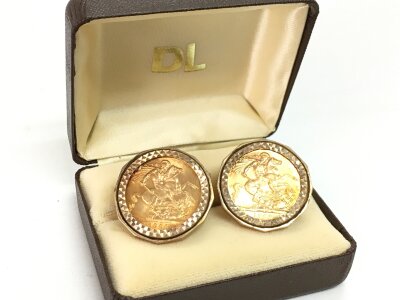 A pair of cufflinks set with 1966 full sovereigns in 9ct gold mounts. 27g total weight