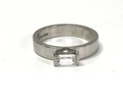 A platinum emerald cut diamond solitaire ring. 0.60ct diamond size L and 6.51g.