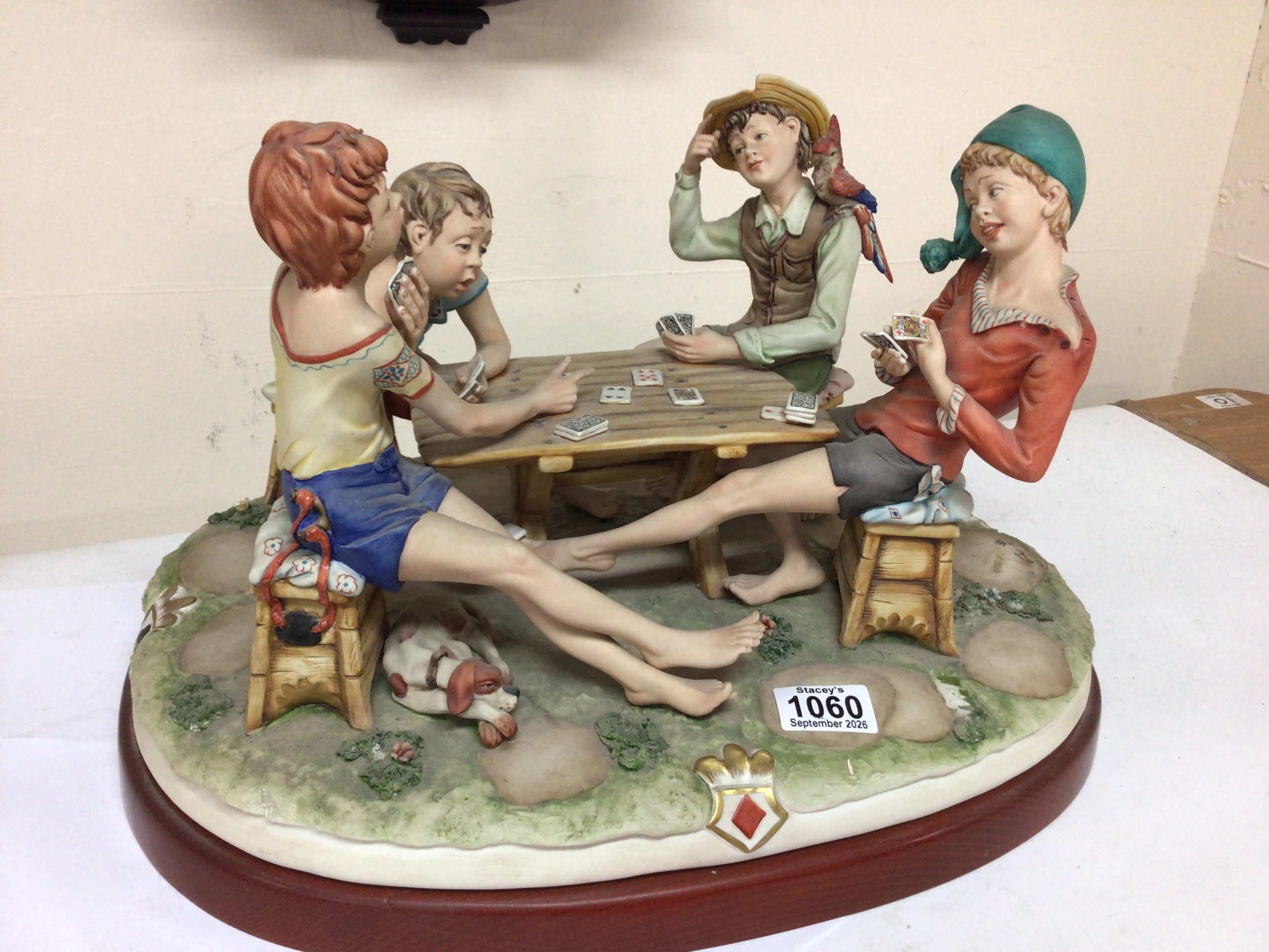  A Capodimonte figure group The Cheat with four young figures playing cards. 